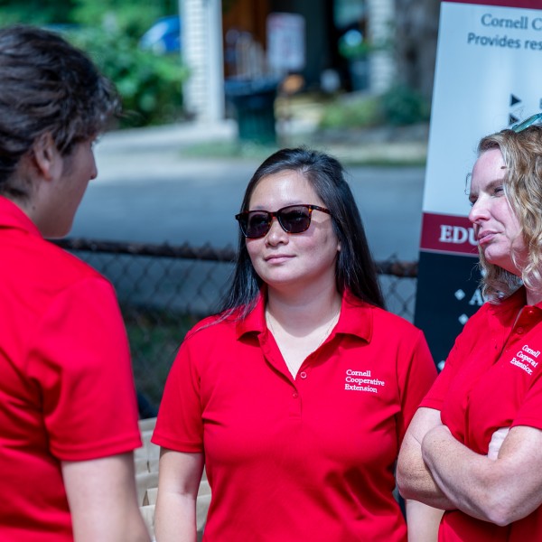Mallory Hohl speaks with colleagues at the South Lawn garden in Rochester, NY.