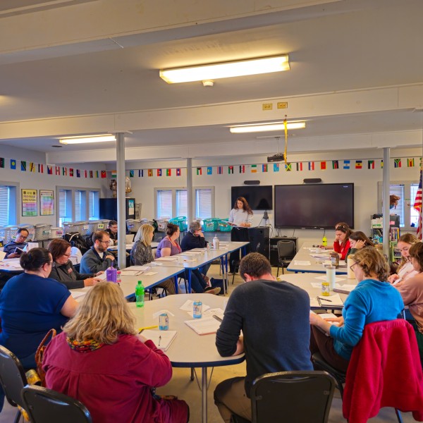 A group of people gathered in a class room. 