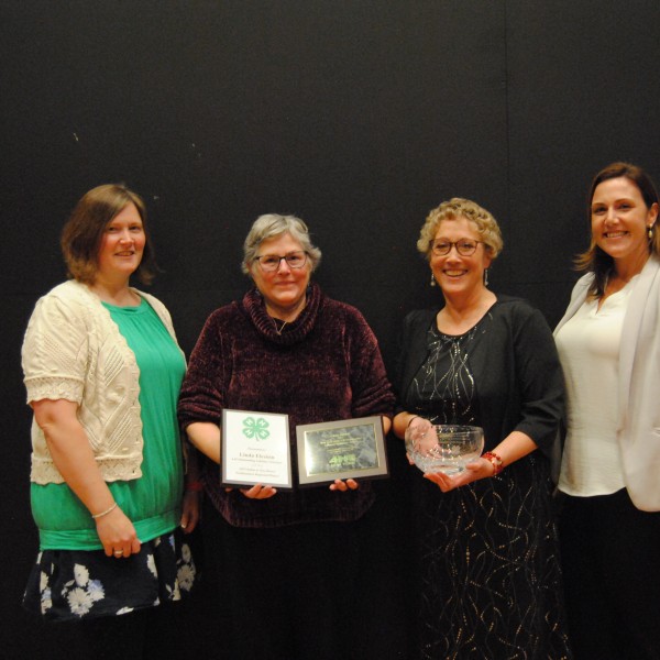 Linda Elcsisin recieving award with Alexa Maile and others