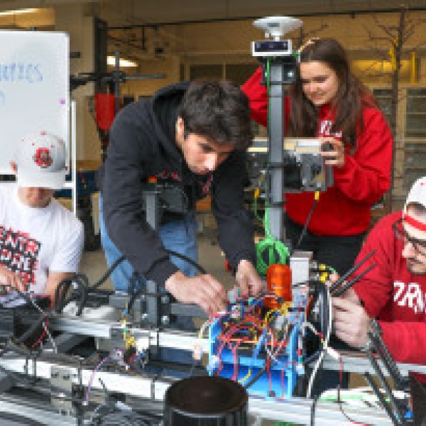 A team of Cornell students work on a prototype of their weed-killing robot