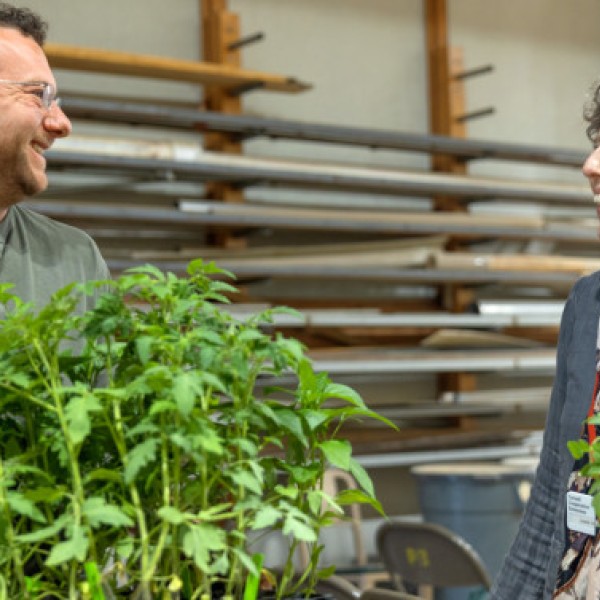 Laurie VanNostrand (right), Cornell Cooperative Extension master gardener coordinator in Wayne County and statewide coordinator for the Vegetable Variety Trial Garden project, chats with a master gardener volunteer at a plant pick-up day on campus on May 12. 