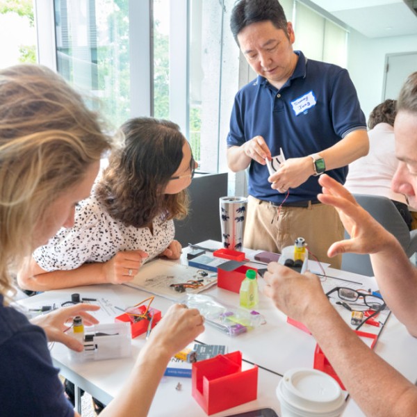 Sunny Jung (standing), professor of biological and environmental engineering in the College of Agriculture and Life Sciences, helps Alisha Stahl, a middle school teacher from Durgee Junior High School in Baldwinsville, New York, at a workshop for teachers on July 29. 