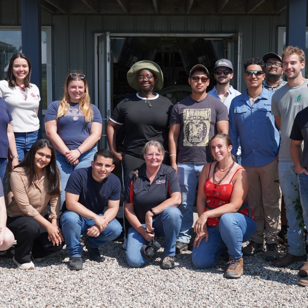 A group of people stand together in front of the facility at the Miner Institute.
