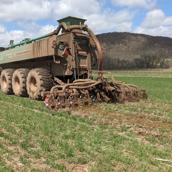 A piece of farm equipment spreads manure.