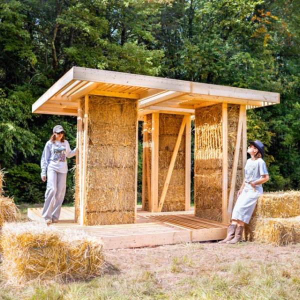 Densely packed straw bales within the interior walls of “BaleWorks,” a design-build installation by Marta Wisniewska constructed recently for BuildFest 2026 in Bethel, New York. 