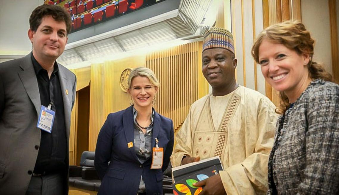Two men and two women standing and smiling