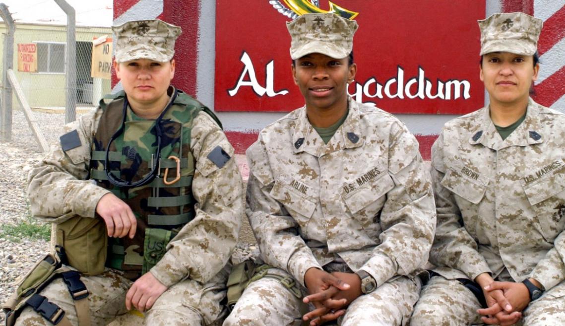 Three marines sitting outside