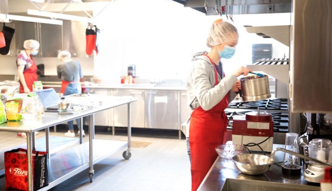 Two students working in Stocking Hall test kitchen on their capstone project