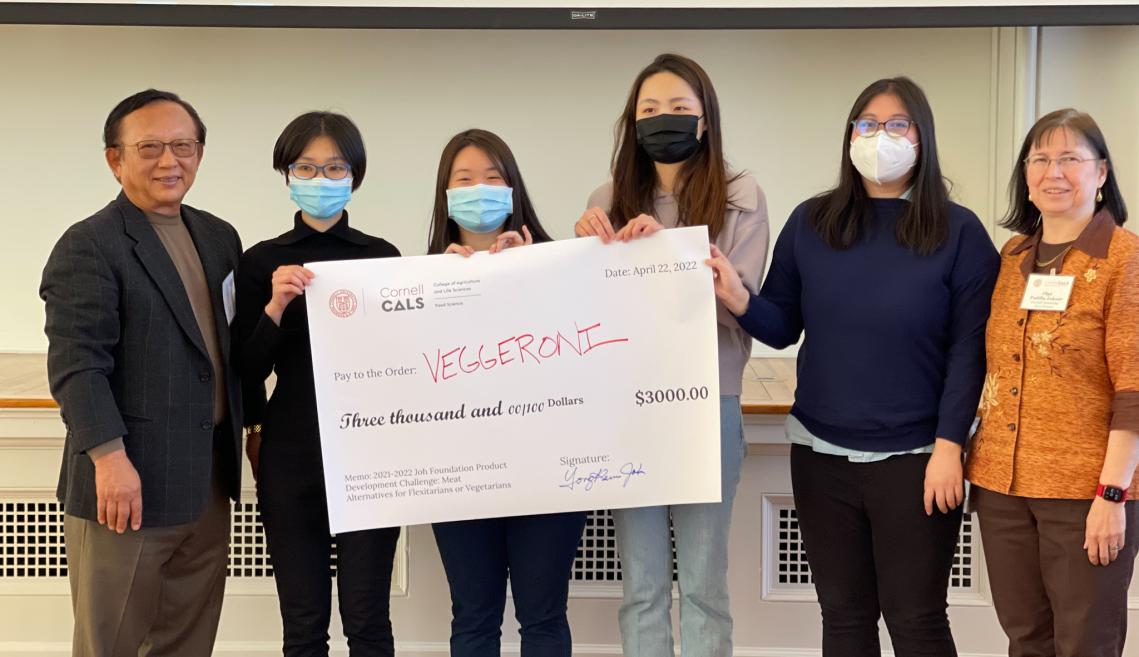 A group poses with a check for second place at the competition.