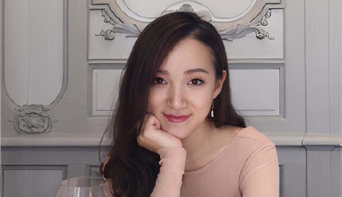 Glycine Jiang in foreground and gray wall with molding in background