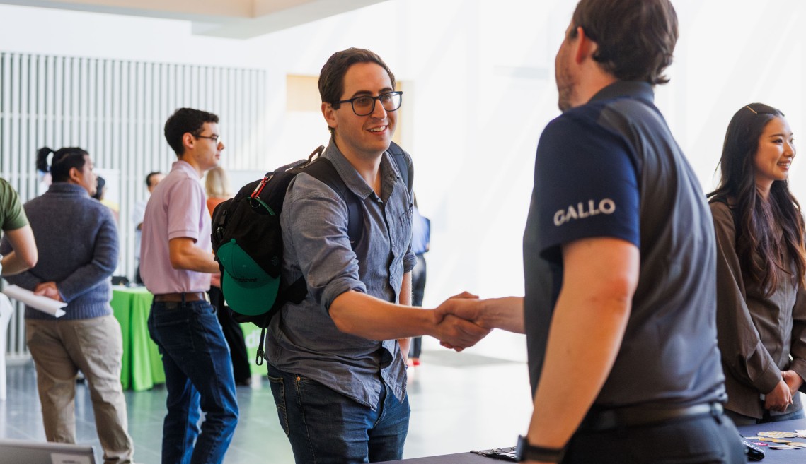 A CIFS member working with a Cornell student at a recruitment event