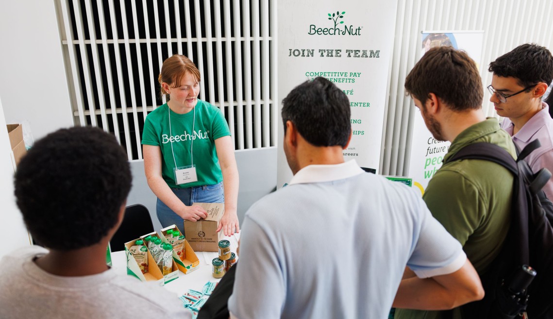 A CIFS member working with Cornell students at a recruitment event
