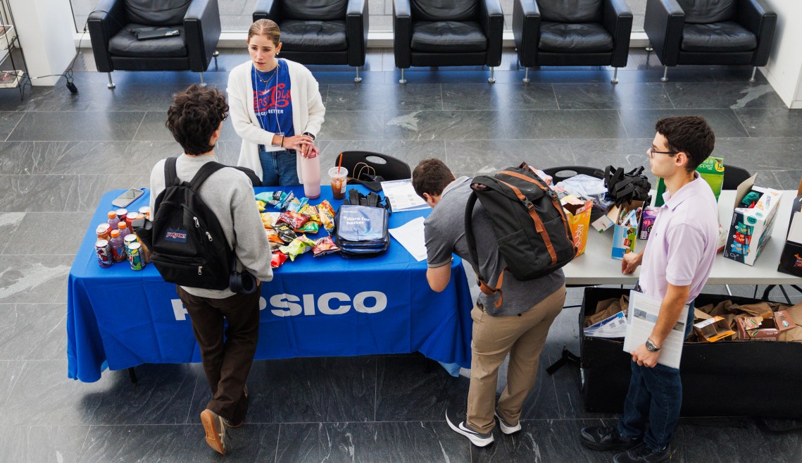 A CIFS member working with Cornell students at a recruitment event