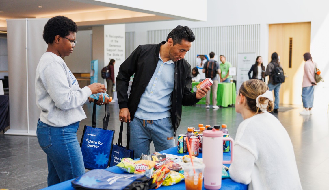 A CIFS member working with Cornell students at a recruitment event