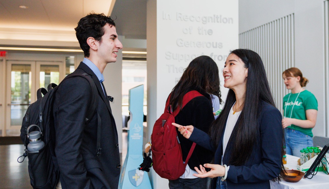 A CIFS member working with a Cornell student at a recruitment event