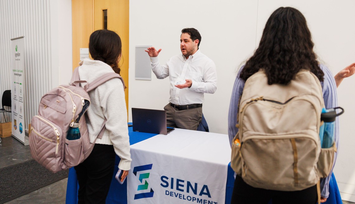 A CIFS member working with Cornell students at a recruitment event