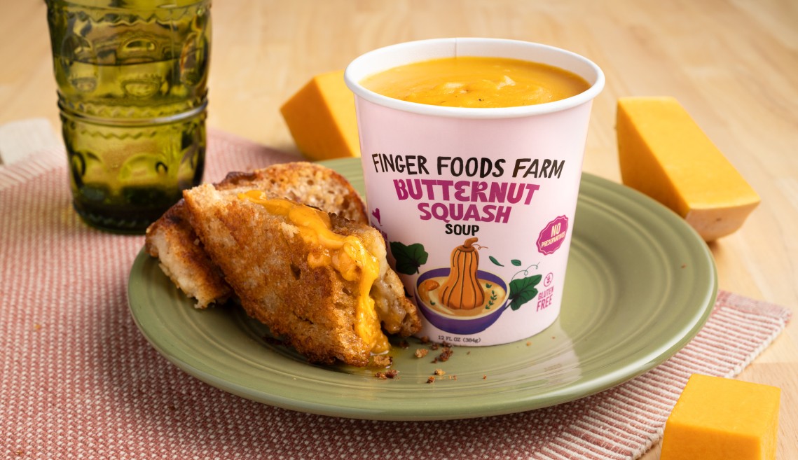 A paper carton of butternut squash soup