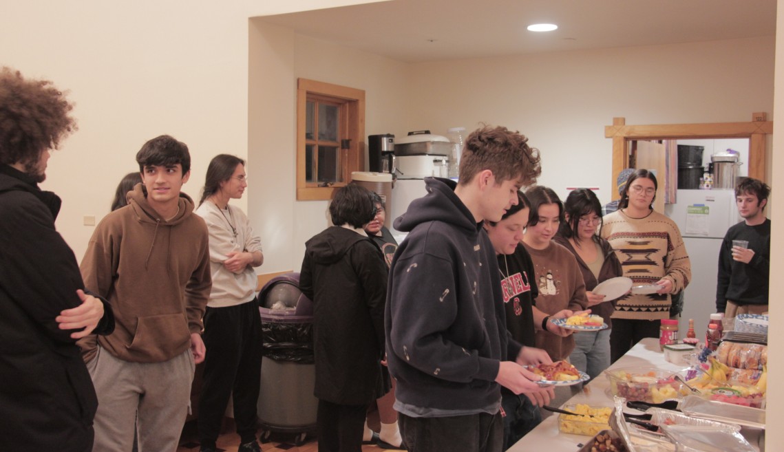 Students wait in line for a buffet.