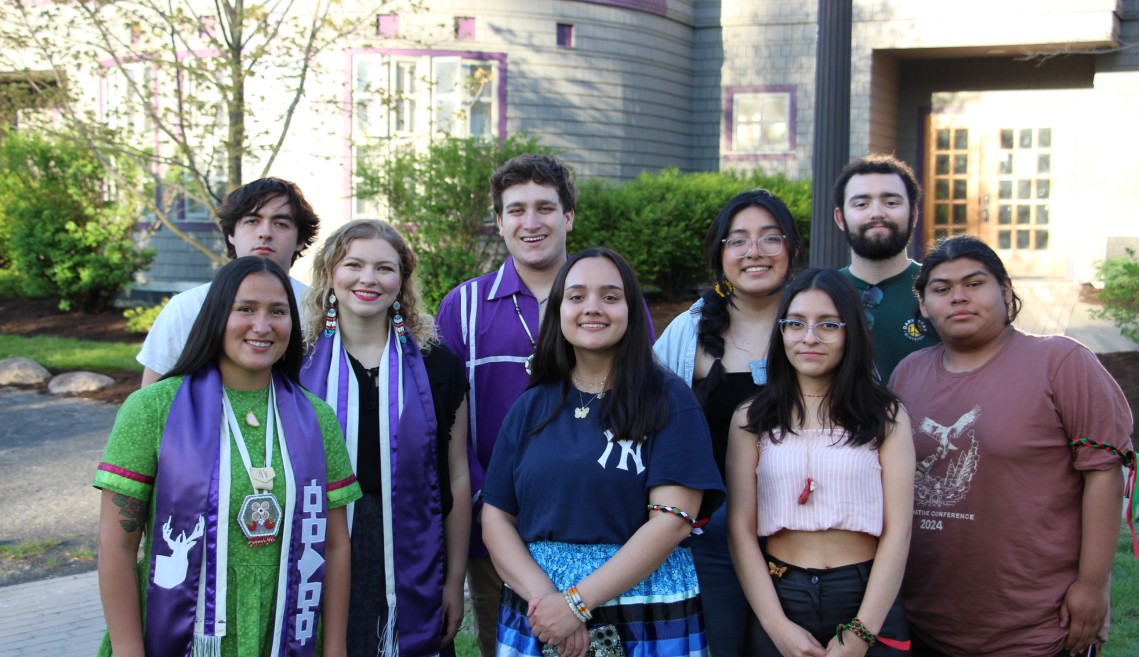 Students stand in front of Akwe:kon smiling.