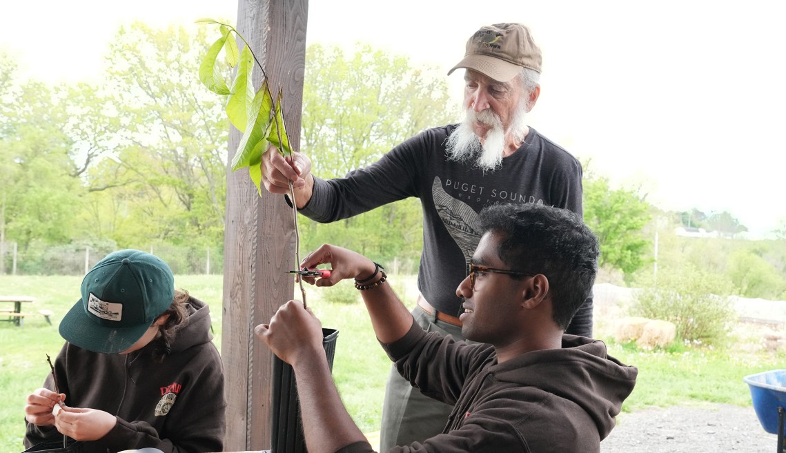 Bob Meadows with students and young trees