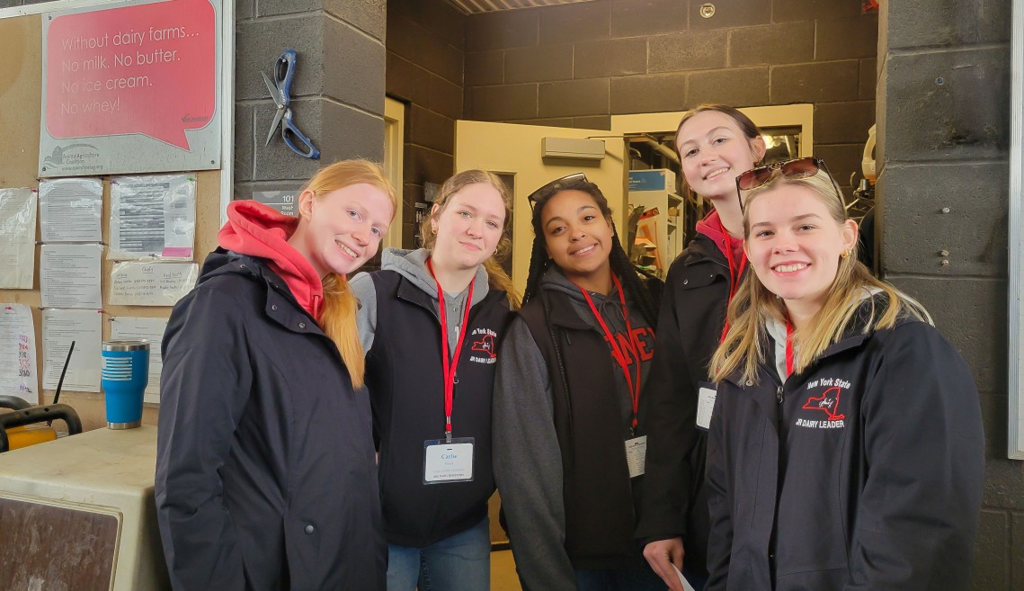 five young people stand together