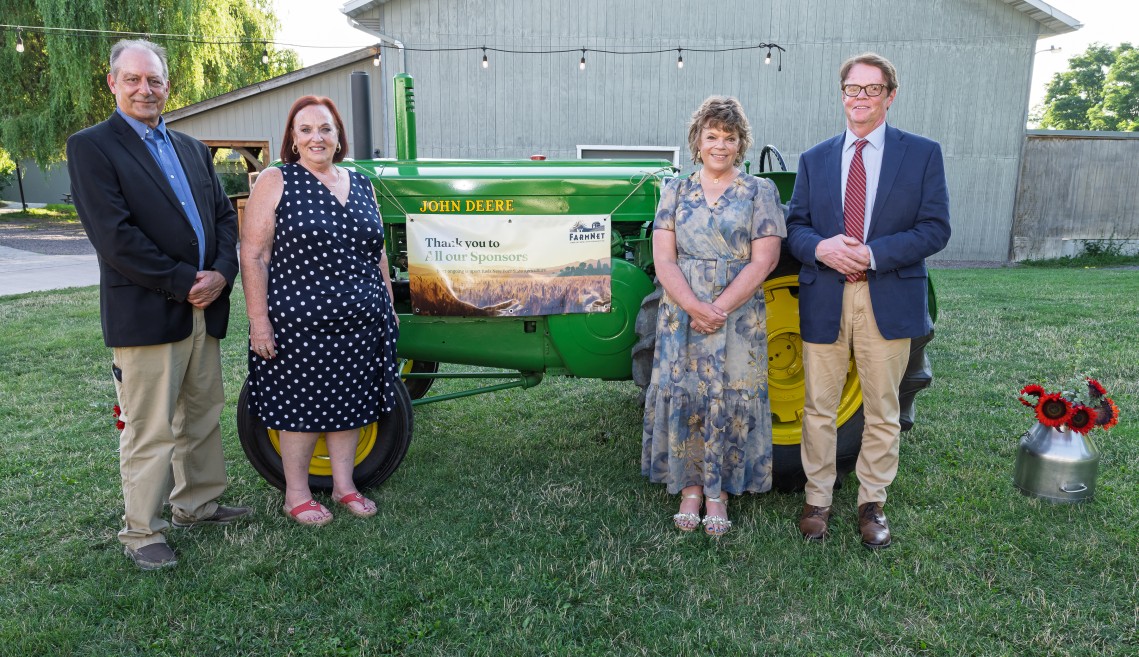 People standing around a tractor.