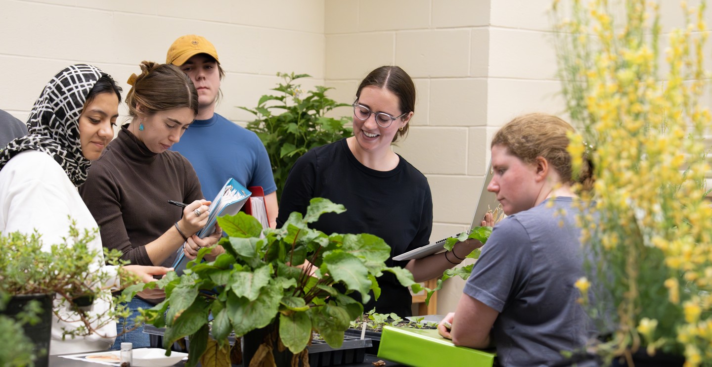 A group of students and plants in a lab