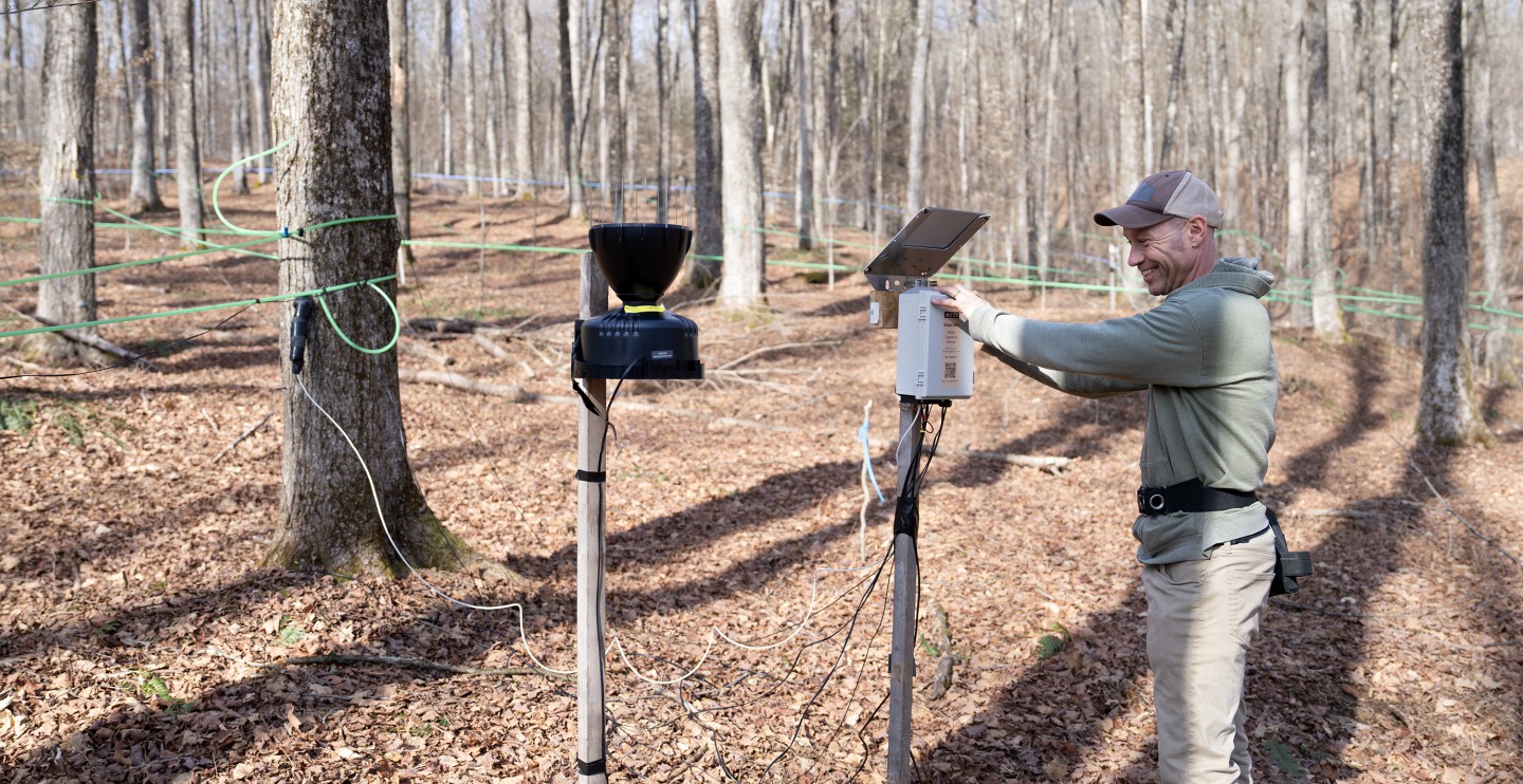 A person checking equipment during sugaring season