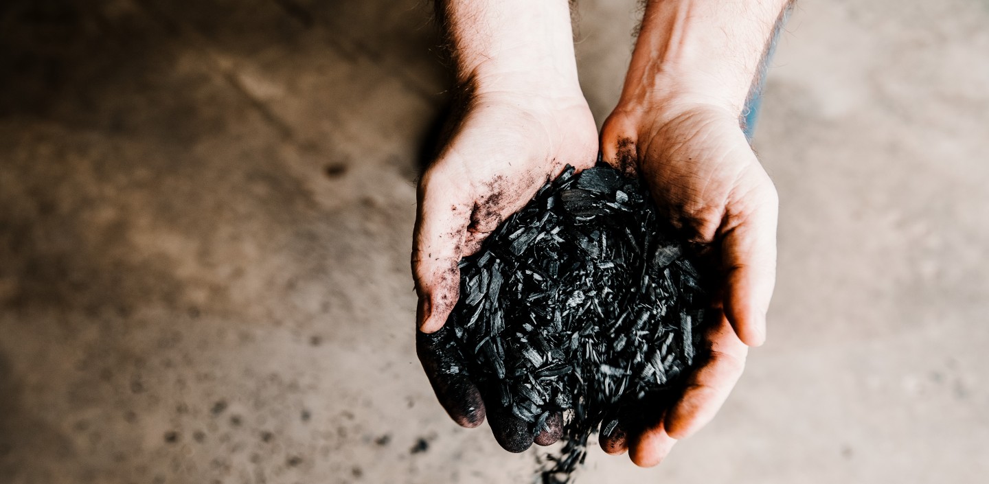 hands hold black ashes