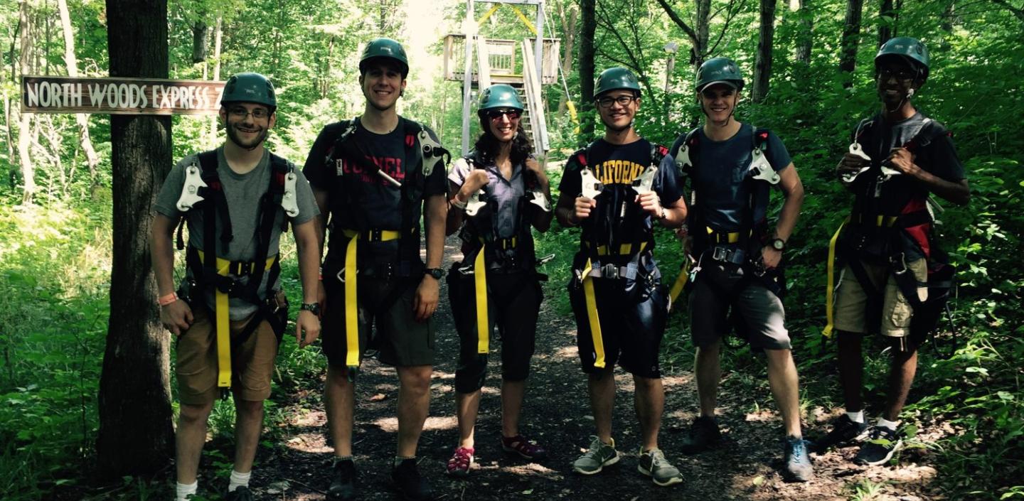A group of people in safety gear in a forest
