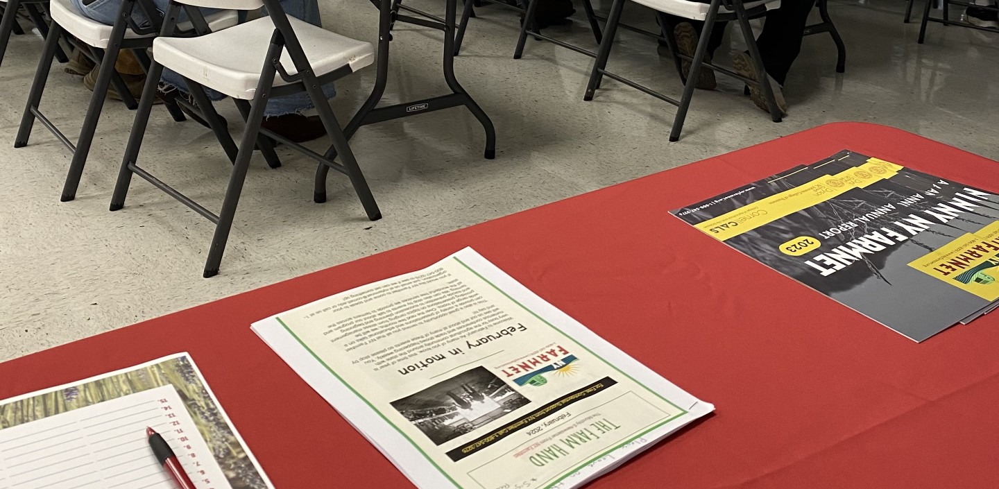 A group of people in a room listening to a presentation. 
