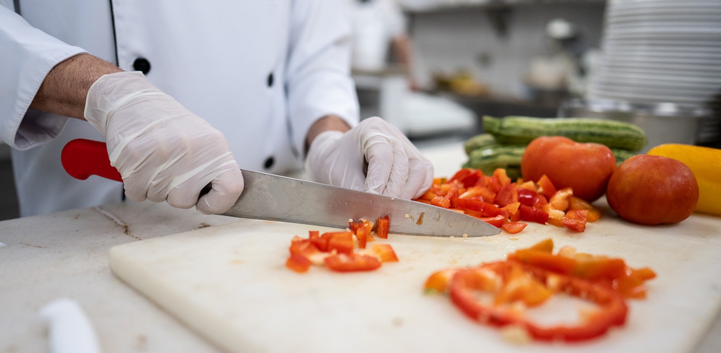 Chef prepares vegetables in a commercial kitchen