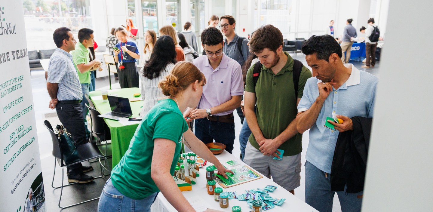 A CIFS member working with Cornell students at a recruitment event