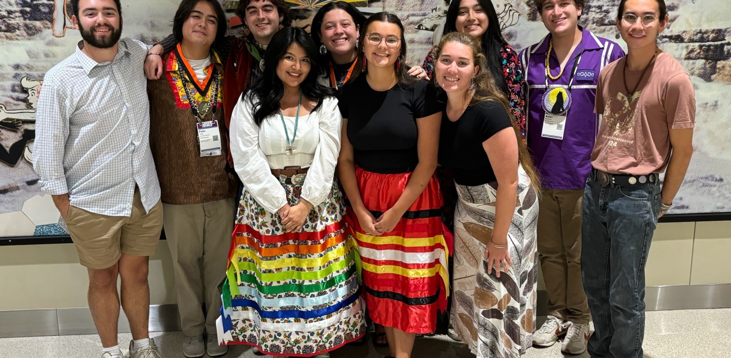 Students smile posed in a group.