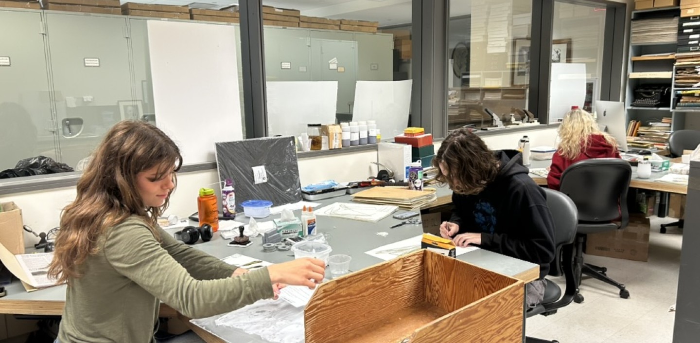 3 students working at BH mounting herbarium voucher specimens