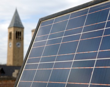 A solar panel in front of McGraw Tower