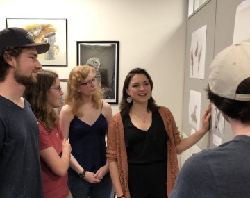 Student Raisa Kochmaruk showcases her work at an art show