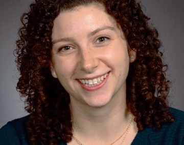 A female sitting and smiling