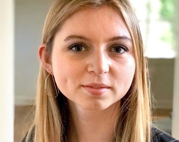 A woman sitting and smiling