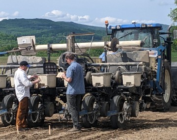 two people talking behind a parked planter