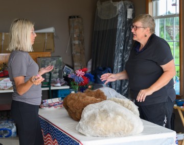 Two people talking at a table. 