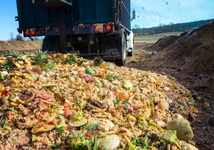 A truck dumps Cornell dining hall food waste at the university’s composting facility