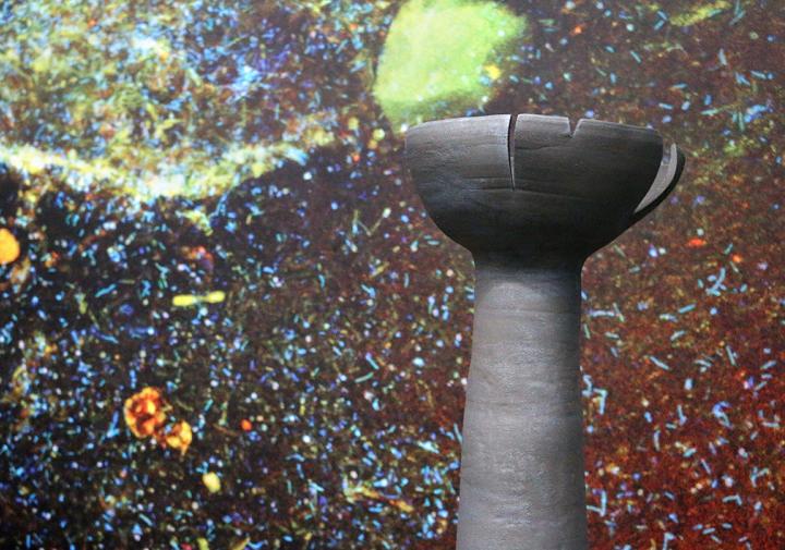 A tall grey cement structure with a large opening at the top