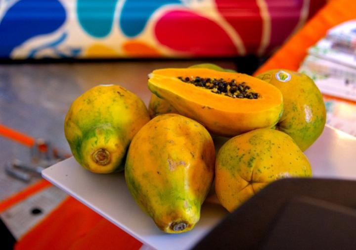 Papaya displayed in front of a colorful food truck