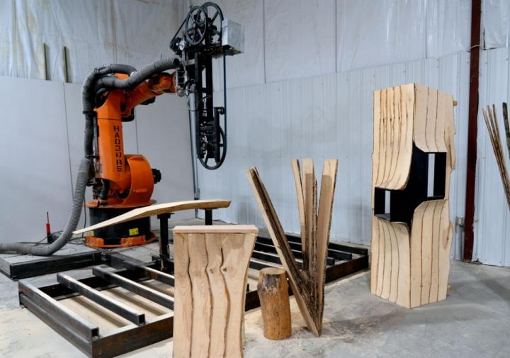 An orange robot and the wood it cut 