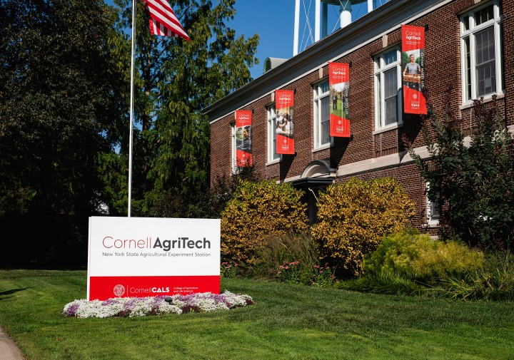A large brick building with a sign out front