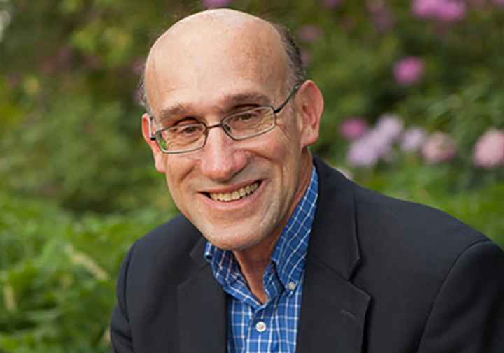 a profile picture of a man smiling