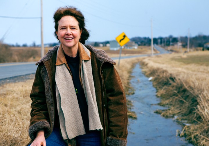 Woman on roadside with overcoat