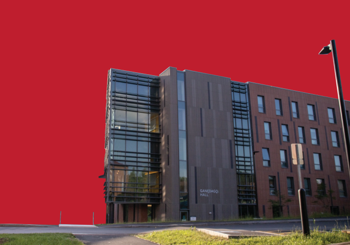 Image of modern dorm building with a bright red background.