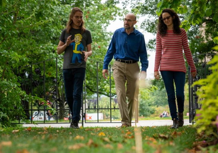 don with students walking through garden